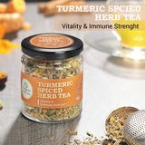 Jar of Turmeric Spiced Herb Tea on a wooden table, accompanied by loose tea leaves and brewing accessories.