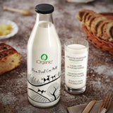 iOrganic A2 Cow Milk, hormone-free with high beta-casein protein, in a reusable glass bottle, served in a clear glass on a rustic table setting, perfect for improving digestion and boosting immunity.