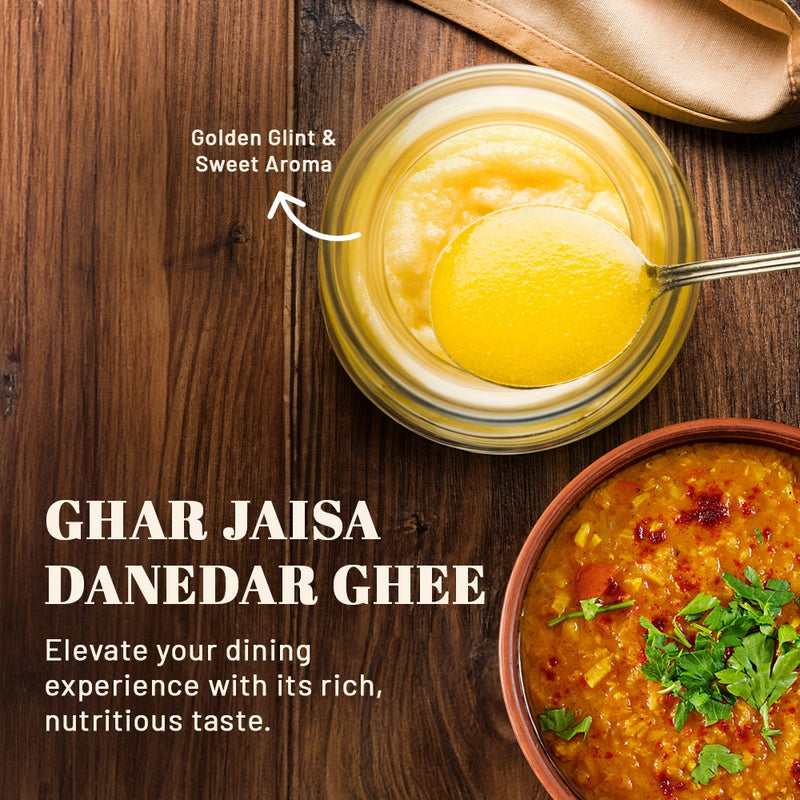 Open jar of iOrganic A2 Desi Cow Ghee with a spoonful of 'Danedar Ghee,' annotated to highlight the authentic Ayurvedic churning process from curd of grass-fed Sahiwal cows, ensuring a granular and nutrient-rich cooking staple.