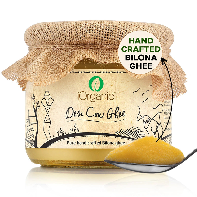 A jar of iOrganic A2 Desi Cow Ghee, made using the Ayurvedic bilona method from gir cow milk, displaying a rich, golden color with a granular texture, perfect for healthy cooking and improving overall wellness.