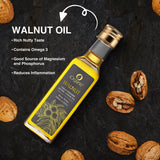 A tilted bottle of iOrganic Cold Pressed Walnut Oil, emphasizing its rich nutty taste, Omega-3 content, and inflammation-reducing properties.