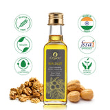 A bottle of iOrganic Cold Pressed Walnut Oil (Roghan Akhrot) with vegan, gluten-free, and ethically sourced certifications, displayed with whole and shelled walnuts.