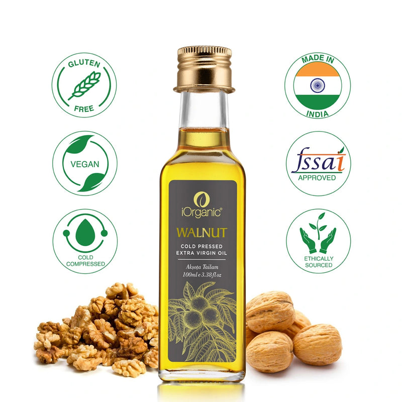 A bottle of iOrganic Cold Pressed Walnut Oil (Roghan Akhrot) with vegan, gluten-free, and ethically sourced certifications, displayed with whole and shelled walnuts.