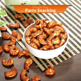 Spicy iOrganic Peri Peri Cashews served in a white bowl on a wooden table, ideal for enhancing your party snacking experience.