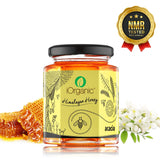 A luxurious jar of iOrganic Acacia Honey with natural honeycomb and a wooden dipper.