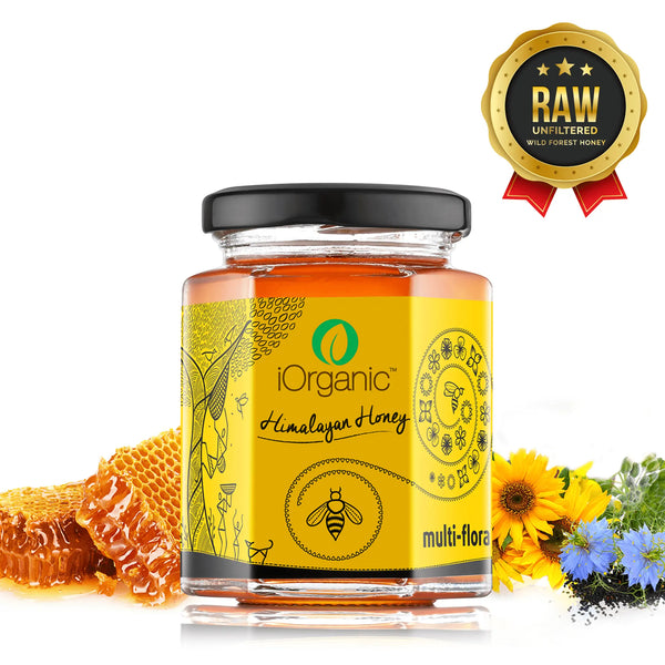 Jar of iOrganic Raw Himalayan Honey, capturing its dark amber glow, sourced from the lush forests of Uttarakhand. The label highlights its rich, complex flavor, perfect for enhancing smoothies, yoghurt, or granola, and details its natural benefits for health and energy