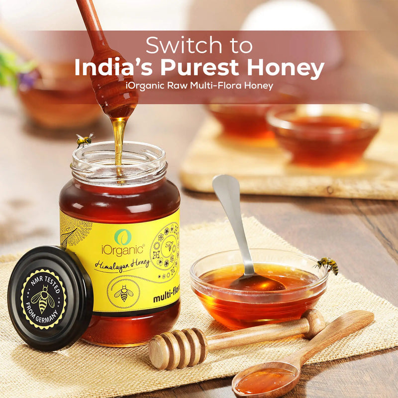 Open jar of iOrganic Raw Honey with a honey dipper, NMR tested seal from Germany, inviting you to switch to India's purest honey, perfect for a natural and organic sweetener.