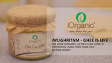 A jar of iOrganic A2 Desi Cow Ghee, made using the Ayurvedic bilona method from Gir cow milk, displaying a rich, golden color with a granular texture, perfect for healthy cooking and improving overall wellness.