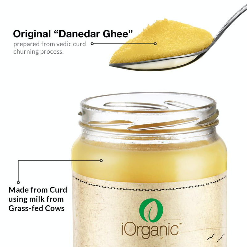 Open jar of iOrganic A2 Desi Cow Ghee with a spoonful of 'Danedar Ghee,' annotated to highlight the authentic Ayurvedic churning process from curd of grass-fed Sahiwal cows, ensuring a granular and nutrient-rich cooking staple.