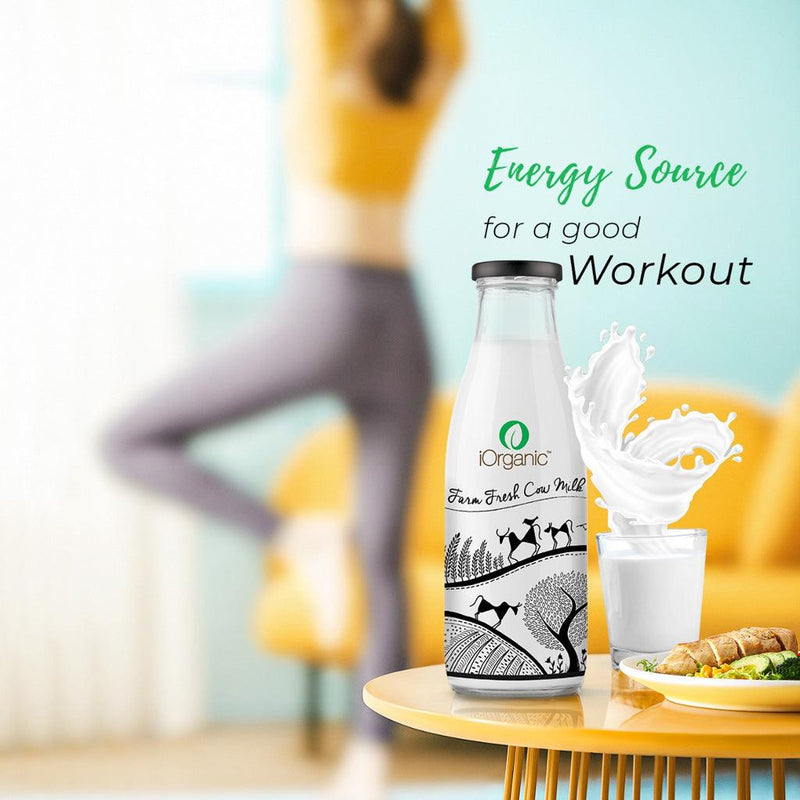 iOrganic A2 Cow Milk, a natural workout energy booster, displayed with a dynamic splash effect on a vibrant yellow table, complementing the active lifestyle theme with a woman exercising in the background.